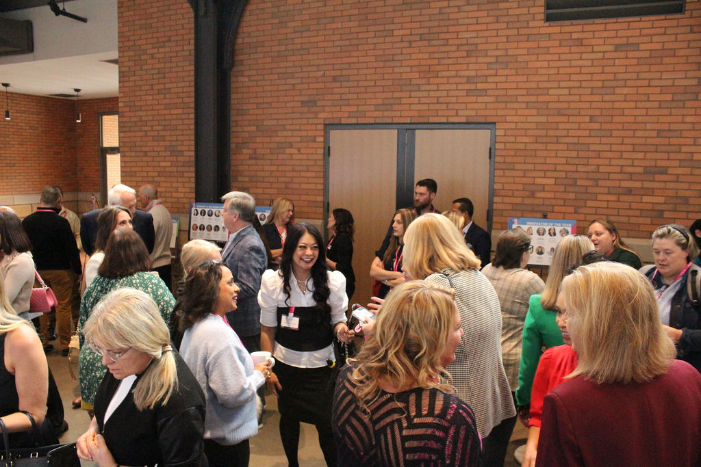 Women of Work attendees networking between sessions in Austin
