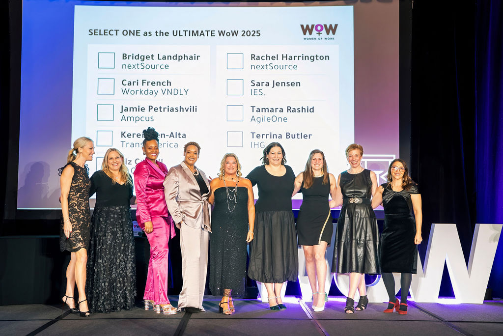 The nine Women of Work award winners on stage with the Ultimate WoW selection screen behind them