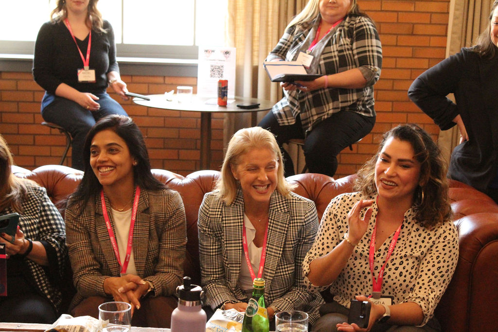 Three women laughing together at Women of Work